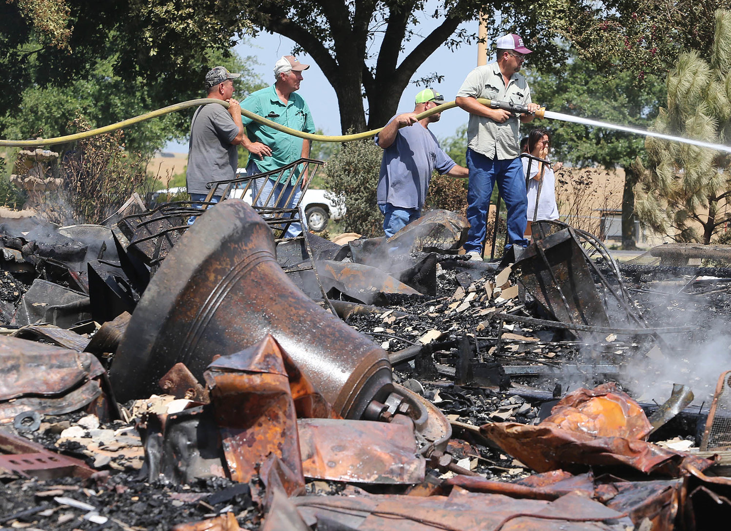 Volunteer firefighters extinguish hot spots July 29, 2019, after fire destroyed the Church of the Visitation in Westphalia, Texas. Since 1883 the parish has served the Catholic community of southwestern Falls County, many of whom are descendents of immigrants from the northwest German region of Westphalia.